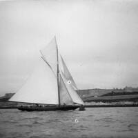 YACHT WITH SIX CREW MEMBERS, CITADEL IN BACKGROUND
