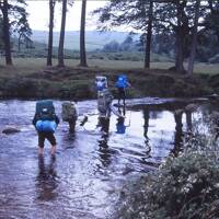 Walkers fording a river