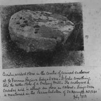 A mill stone in an enclosure at King's Oven