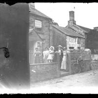 Family group outside cottage in Lydford