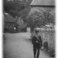 A lustleigh postman delivering through the village