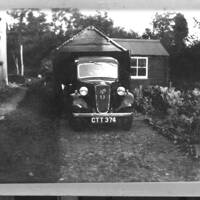 Old Austin in front of garage at Manaton