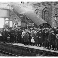 1WW SERVICEMEN, NEW RECRUITS, WIVES AND CHLDREN WAIT FOR THE TRAIN AT AXMINSTER RAILWAY STATION;  