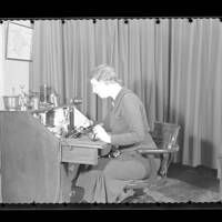 Sydney Taylor's wife, Marjorie, making a  telephone call.