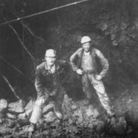 Miners standing inside rediscovered mineworkings at Kelly Mine