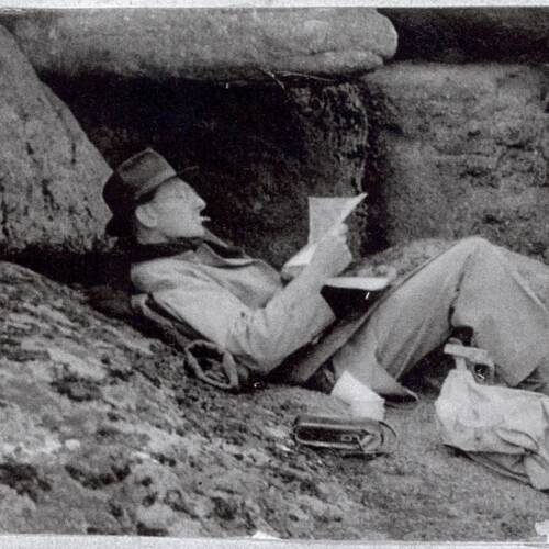 John Waterfield finding shelter to read under the rocks at Hound Tor