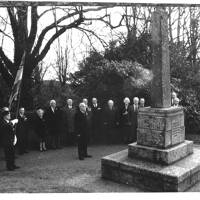 Members of the British Legion standing before the Manaton War Memorial