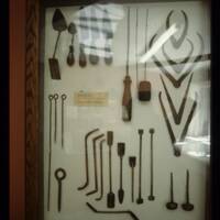 Tools used at Glass's Iron Foundry displayed in a glass cabinet