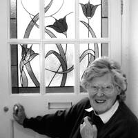 Anne Beaumont with her stained glass window