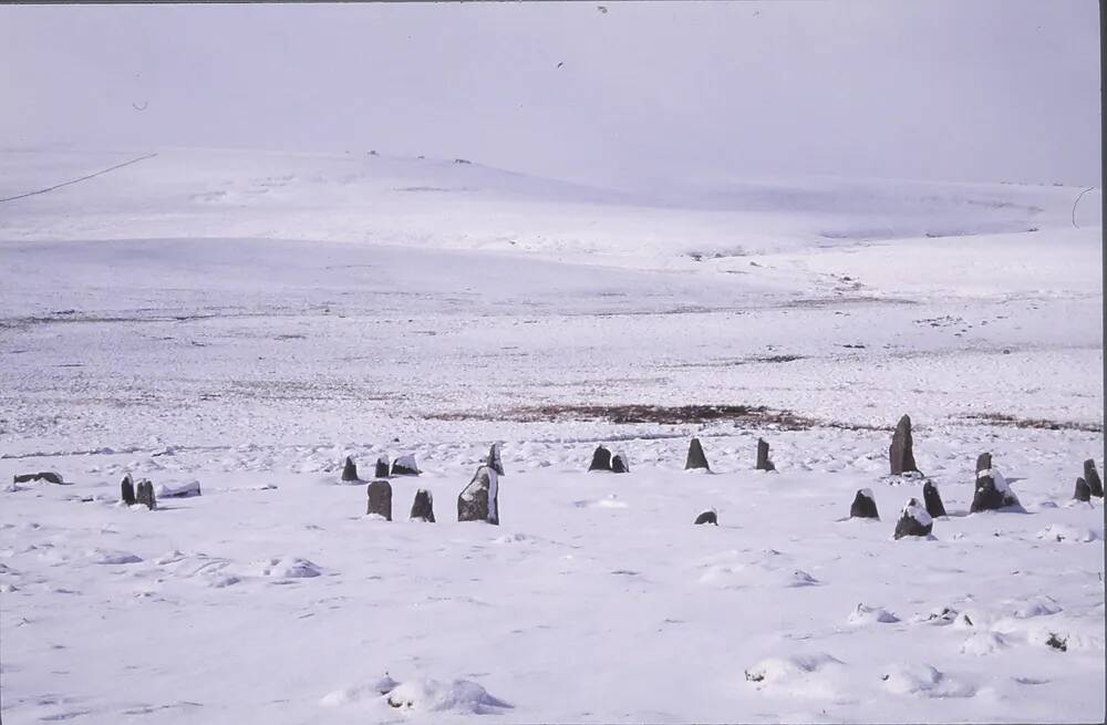 Snow scene of White Moor stone circle at Widecombe in the Moor 