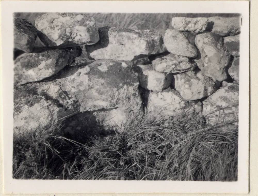 A mould stone incorporated in a stone wall at Ringhill, near Postbridge