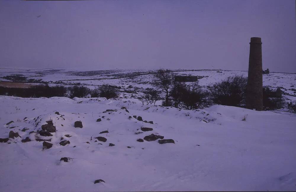 Snow scene of Widecombe in the Moor with chimney in foreground