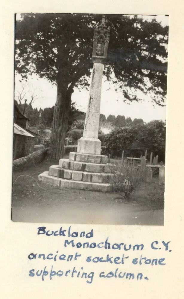 An ancient socket stone supporting a column in Buckland Monachorum Church Yard