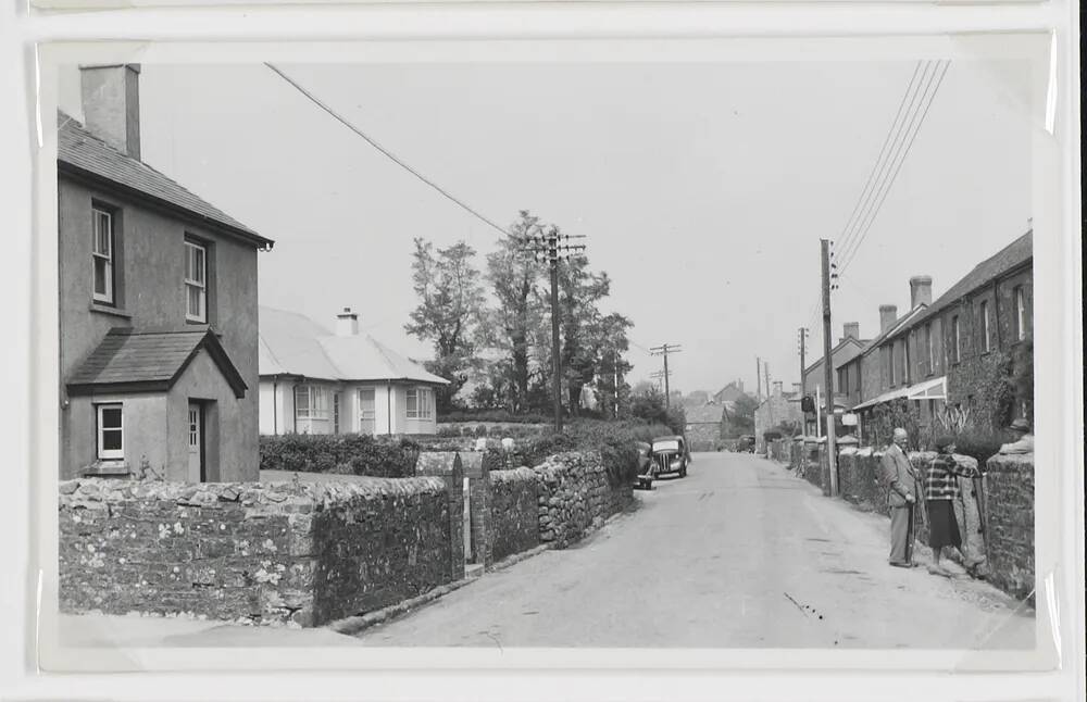 House and car on residential street.